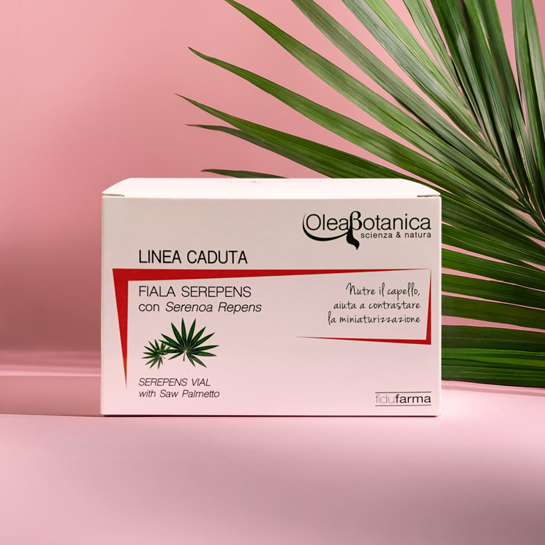 scatola fiala anticaduta fidufarma su sfondo rosa con a sinistra delle foglie verdi che fuoriescono