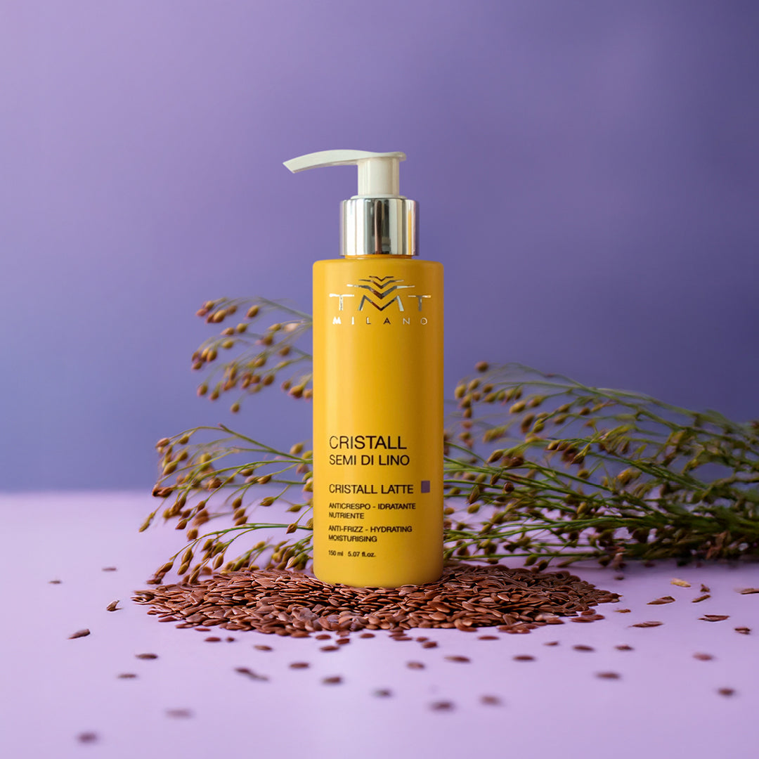 Prodotto Tmt Cristalli anti crespo con sfondo neutro viola con a destra e sinistra la spiga di semi di lino