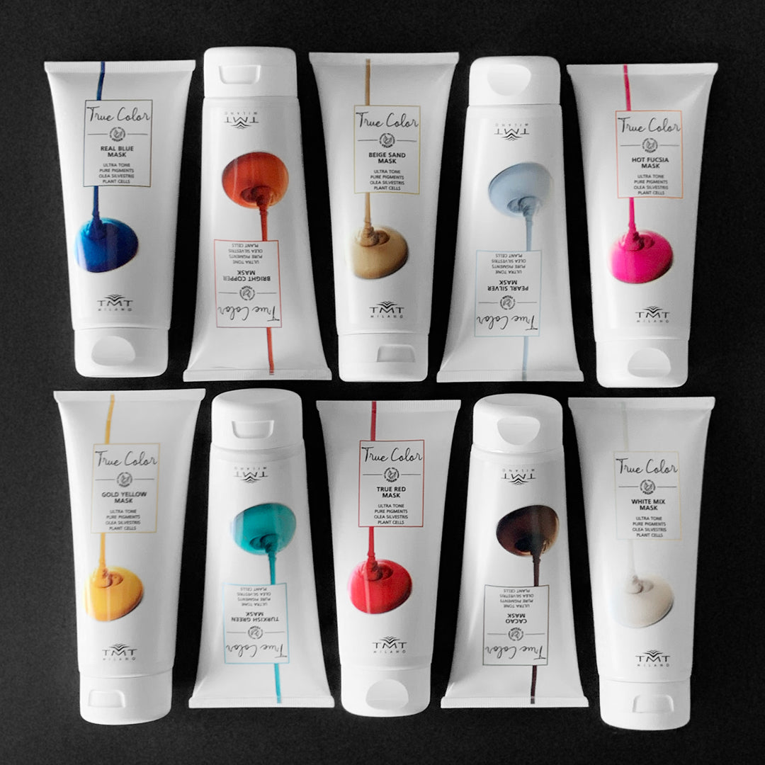 tubi bianchi di masschere colorate che poggiano su sfondo grigio