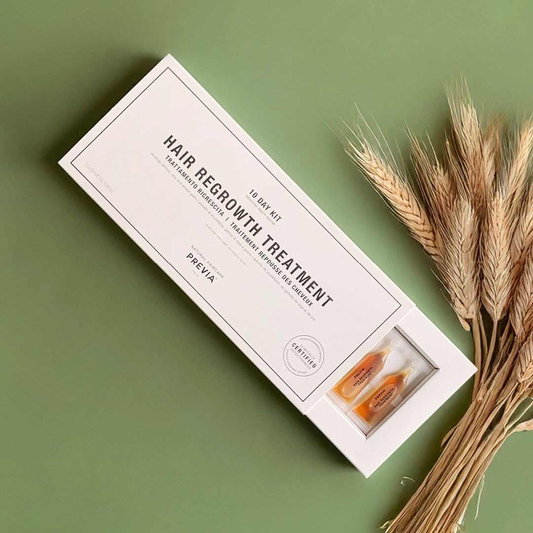 scatola del trattamento riscrescita su sfondo verde con alla sinistra delle spighe di grano