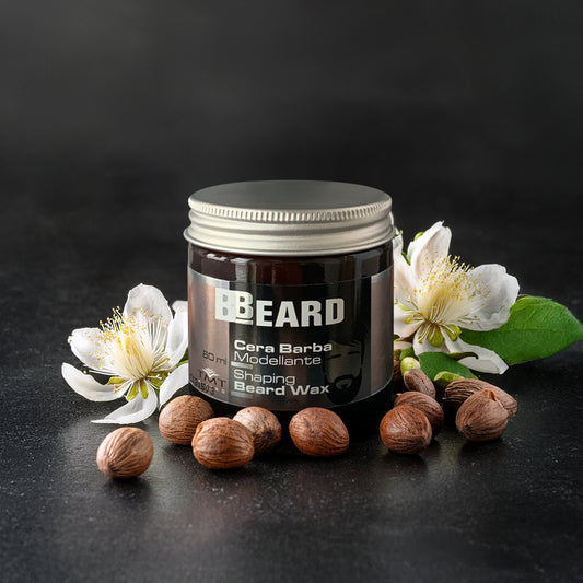vaso beard di cera arba che poggia su un marmo grigio con attorno magnolia e nocciole