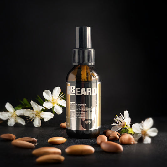 falcone beard di fluido barba che poggia su sfondo di marmo grigio con attorno magnolia e pinoli
